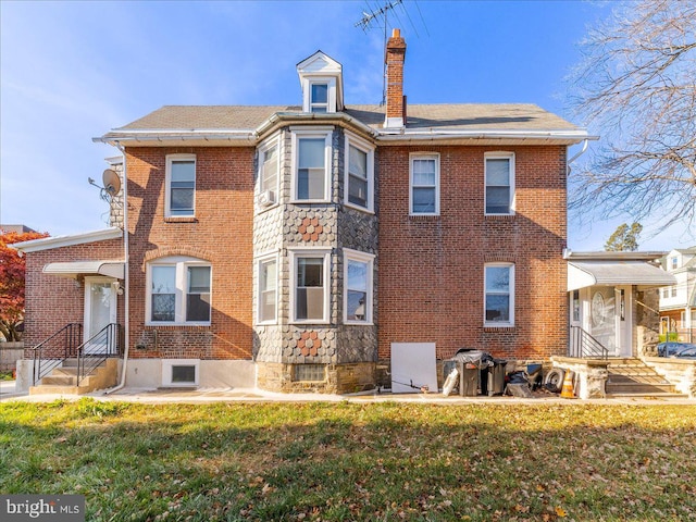 rear view of house with a lawn