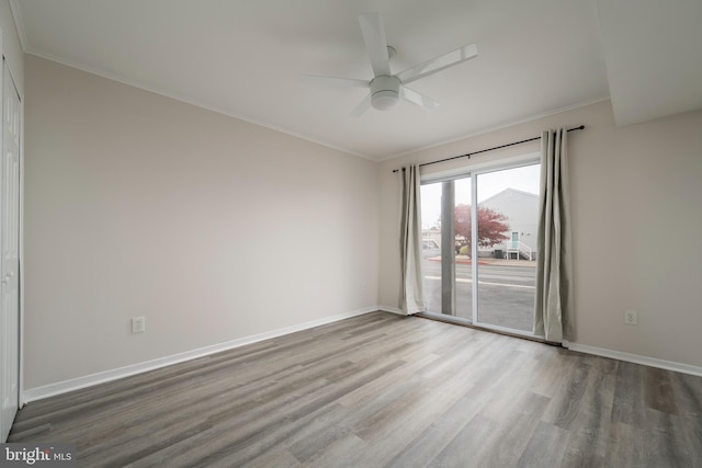 empty room with hardwood / wood-style floors, ceiling fan, and ornamental molding