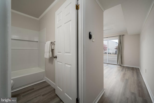 bathroom featuring hardwood / wood-style flooring, toilet, and ornamental molding