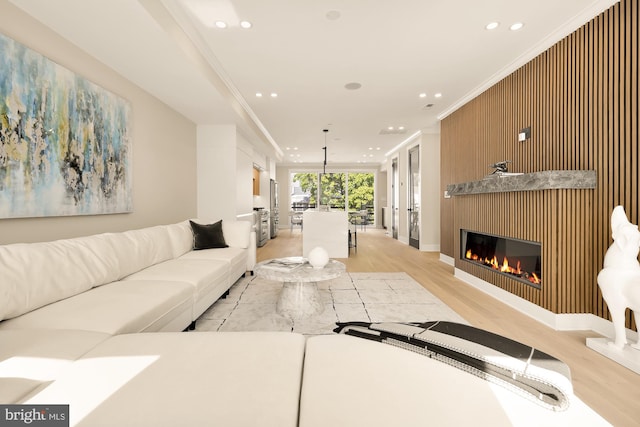 living room featuring light hardwood / wood-style flooring and ornamental molding