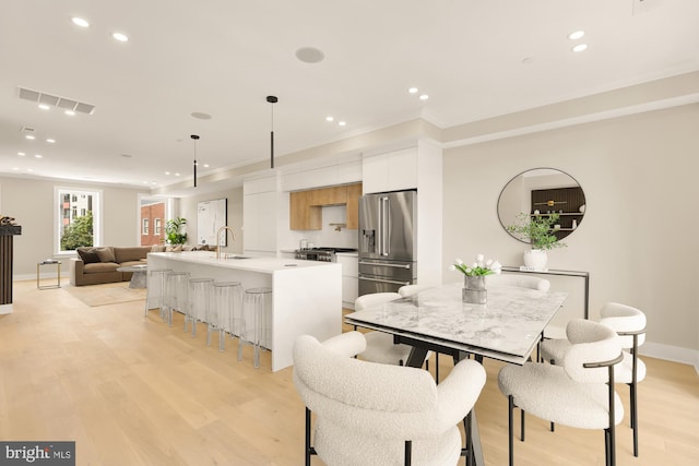 dining area featuring sink and light hardwood / wood-style floors