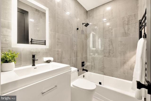 full bathroom featuring vanity, shower / bathing tub combination, tile walls, and toilet