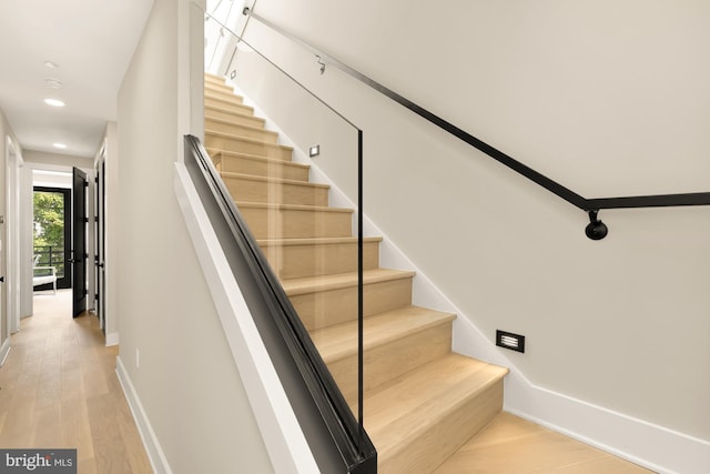 stairway with hardwood / wood-style flooring