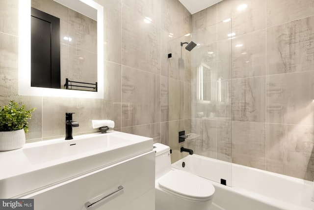 full bathroom with backsplash, vanity,  shower combination, tile walls, and toilet