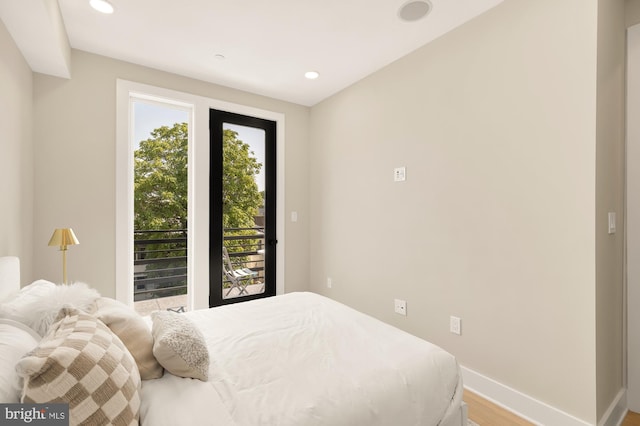 bedroom featuring hardwood / wood-style floors and access to outside