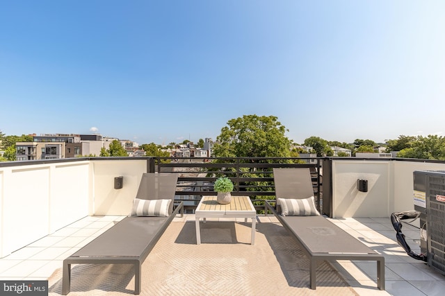 view of patio / terrace with a balcony and central AC unit