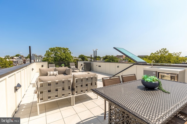 view of patio / terrace with an outdoor hangout area and sink