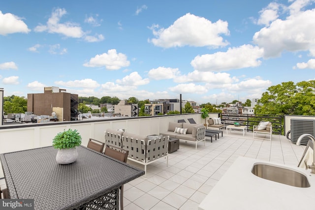 view of patio / terrace featuring an outdoor living space and sink