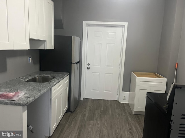 kitchen featuring white cabinets, dark hardwood / wood-style flooring, sink, and stone counters