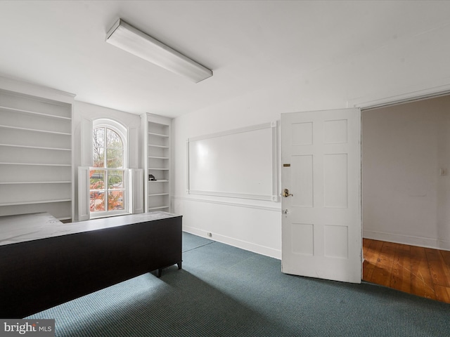 unfurnished office featuring dark hardwood / wood-style floors