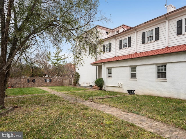 back of property featuring a yard