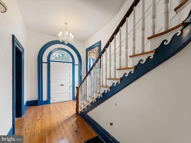 foyer featuring a chandelier and hardwood / wood-style flooring