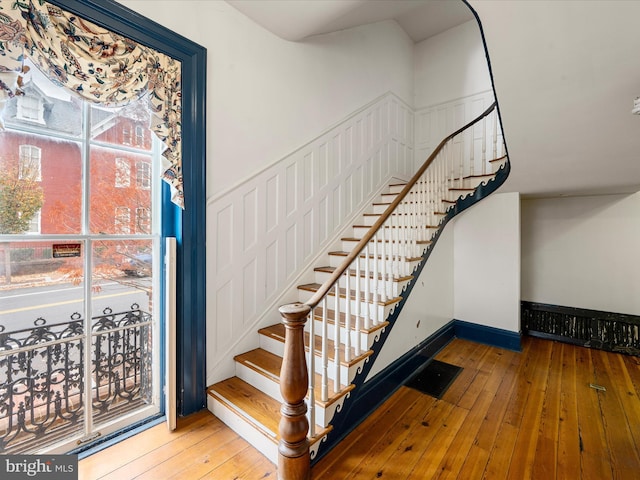 stairs with hardwood / wood-style floors