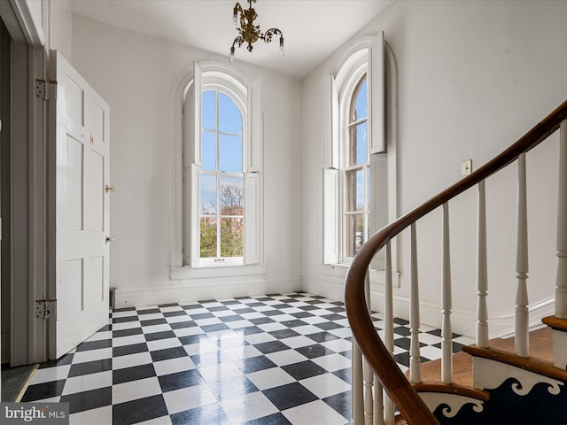 foyer entrance featuring a chandelier