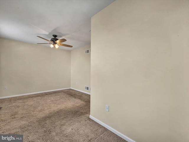 carpeted spare room with ceiling fan