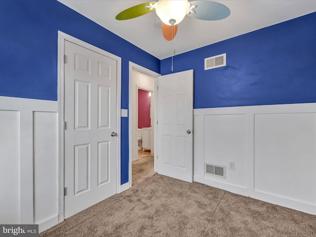 unfurnished bedroom with carpet flooring and ceiling fan