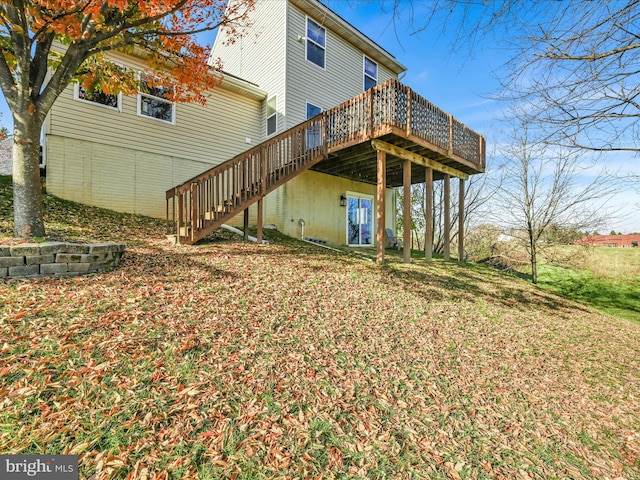 rear view of house featuring a deck