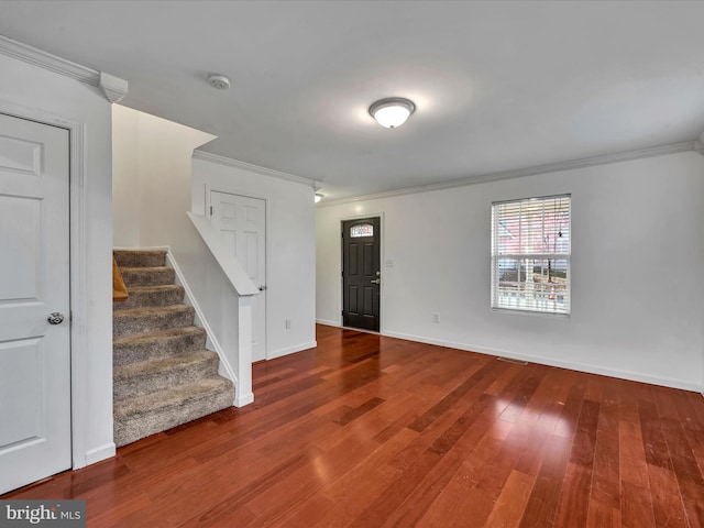 entrance foyer featuring wood-type flooring and crown molding