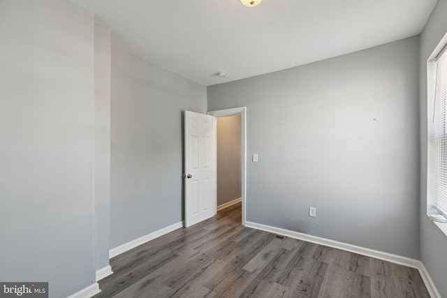 spare room featuring dark wood-type flooring