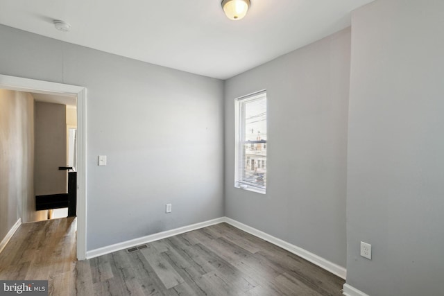 unfurnished room featuring hardwood / wood-style floors