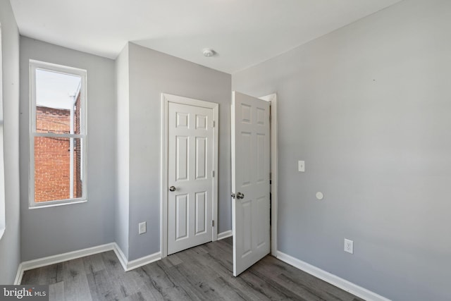 unfurnished bedroom with hardwood / wood-style floors