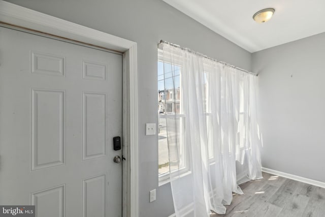 doorway to outside with light hardwood / wood-style floors and a wealth of natural light