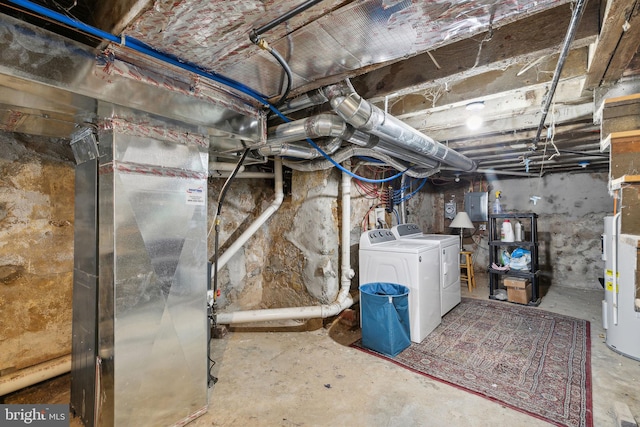 basement with washer and dryer, electric water heater, and electric panel