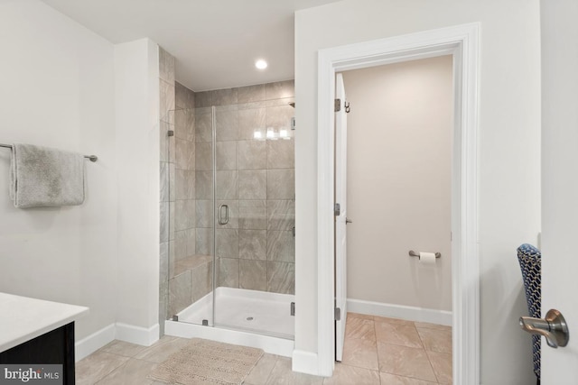 bathroom with tile patterned flooring, vanity, and an enclosed shower