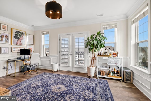 office with wood-type flooring, crown molding, and french doors