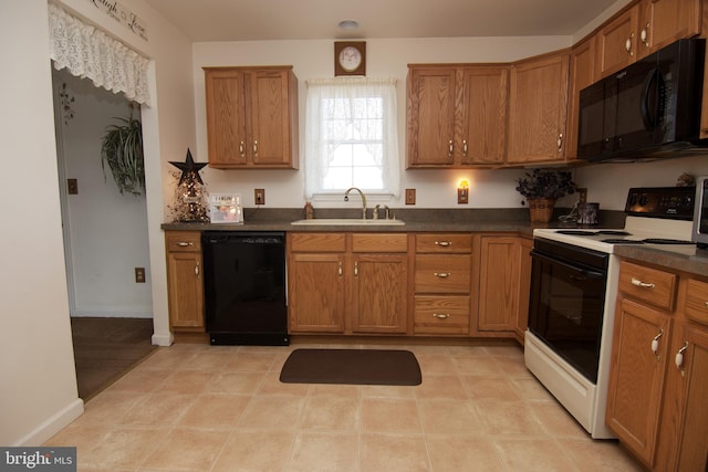 kitchen with light tile patterned floors, sink, and black appliances