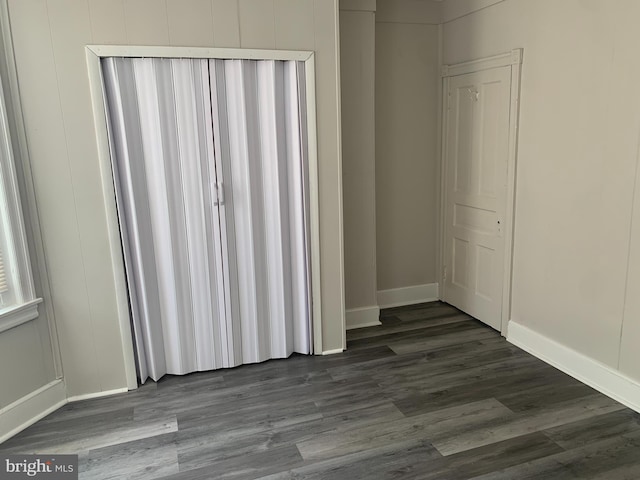 unfurnished room featuring dark hardwood / wood-style flooring