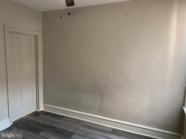 spare room featuring ceiling fan and dark hardwood / wood-style flooring