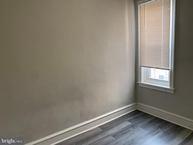 spare room with dark hardwood / wood-style flooring