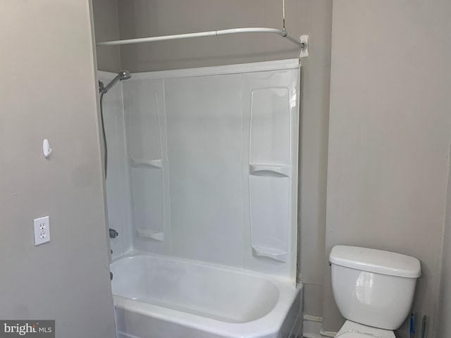 bathroom with shower / bathing tub combination and toilet