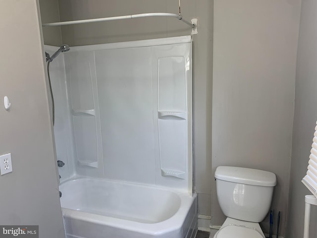 bathroom featuring shower / bathtub combination and toilet