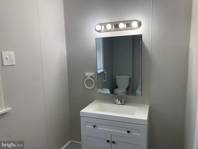 bathroom featuring vanity and toilet