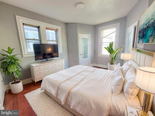 bedroom with dark wood-type flooring