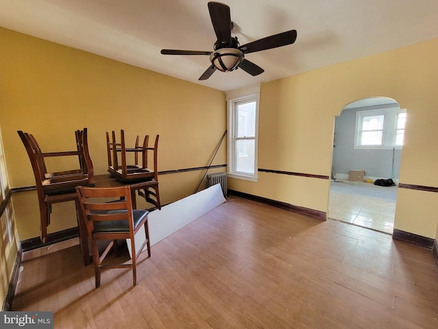 interior space featuring hardwood / wood-style floors, ceiling fan, and radiator heating unit