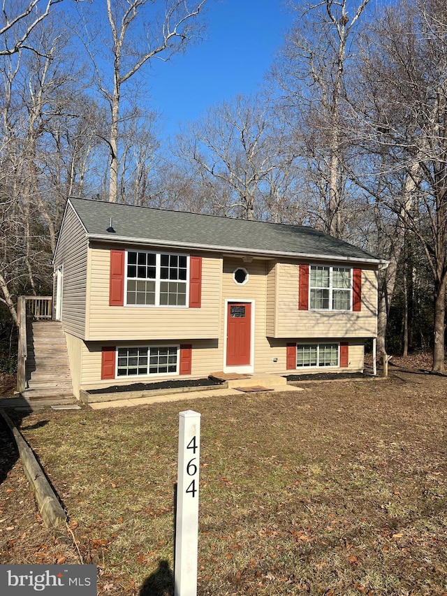 split foyer home with a front lawn