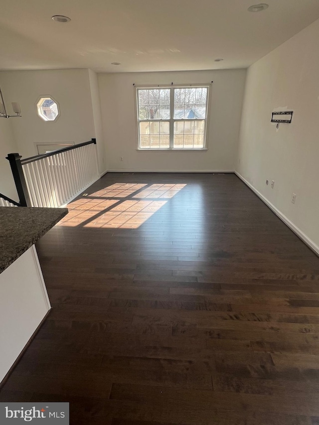 unfurnished room with dark hardwood / wood-style floors