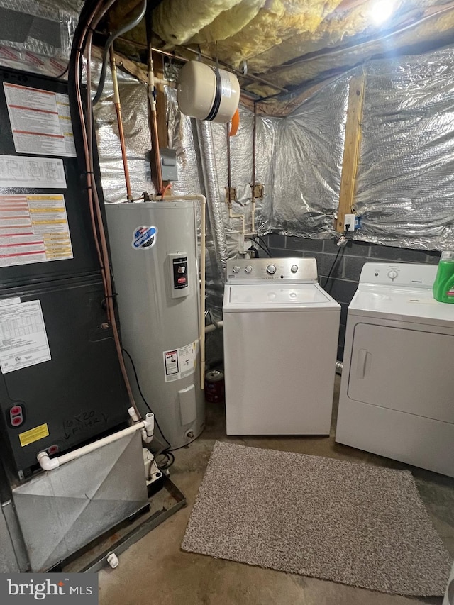 clothes washing area with washer and clothes dryer and electric water heater