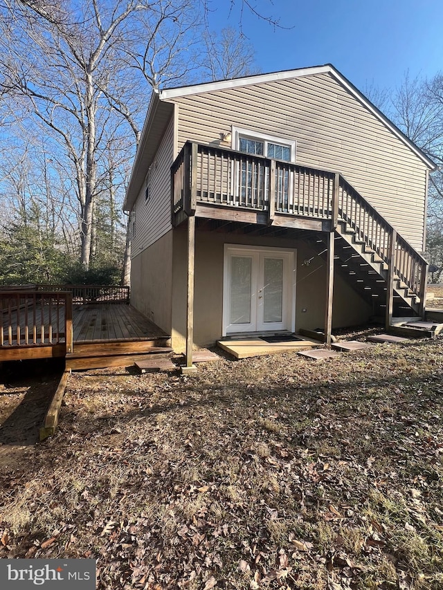 rear view of property with french doors and a deck