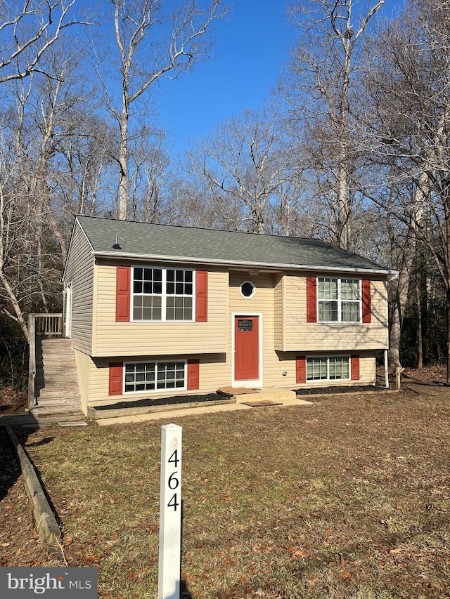 raised ranch with a front yard