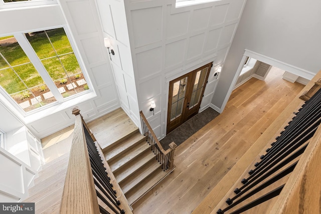 foyer entrance featuring french doors and light wood-type flooring