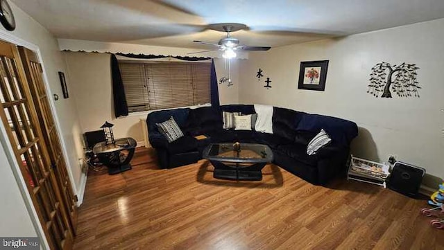 living room featuring hardwood / wood-style floors and ceiling fan