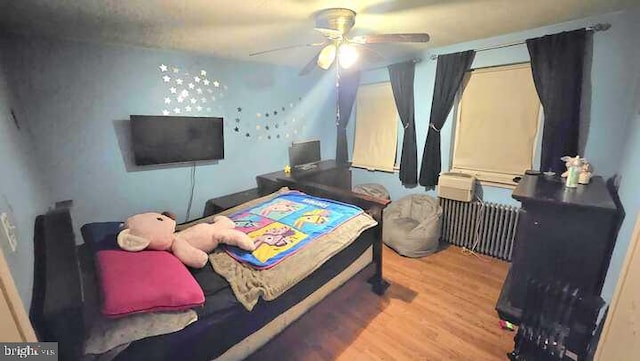 bedroom featuring hardwood / wood-style floors and ceiling fan