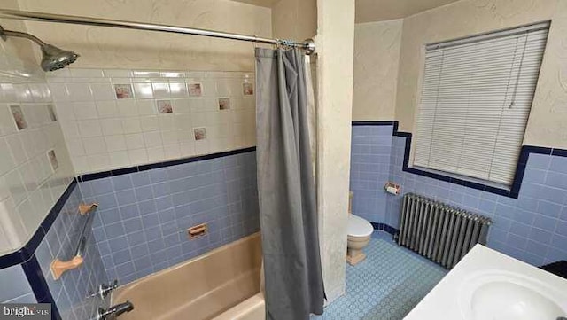 bathroom featuring shower / bath combination with curtain, radiator, tile walls, tile patterned flooring, and toilet