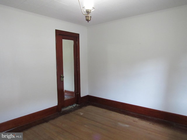 unfurnished room featuring crown molding and dark hardwood / wood-style floors