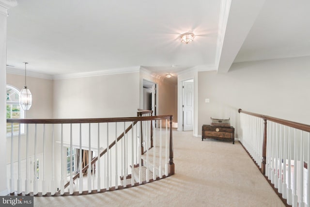 hallway featuring light colored carpet, crown molding, and a chandelier