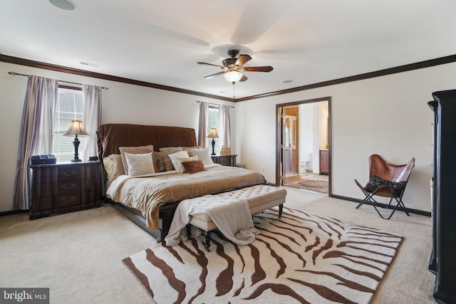 bedroom with ceiling fan, light colored carpet, ensuite bathroom, and multiple windows